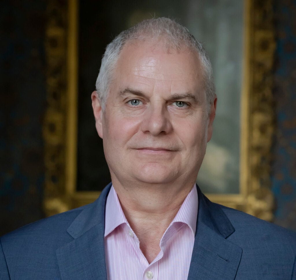 Headshot of trustee Kevin Braim in a blue suit
